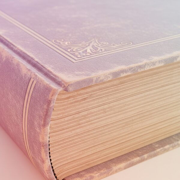 A close-up of an open, aged book showing yellowed pages and a soft, worn texture.